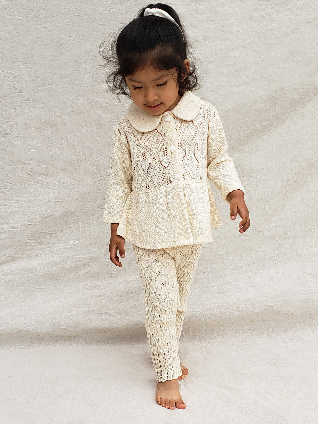 Our Ellen Jacket is the perfect addition to your little girlâs wardrobe! A beautifully crafted knitted jacket with a unique leaf-inspired pattern and captivating rounded flat collar. All in stylish A-fit silhouette with wooden buttons. Sheâll look (and feel!) extra special in this elegant and one-of-a-kind piece! Liten Aventuris Colelctions. Bomullsjacka, Barnjacka, Babyjacka.